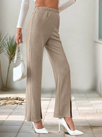 Person wearing beige pants with a white background