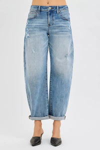 Light blue jeans with a rolled hem on a white background