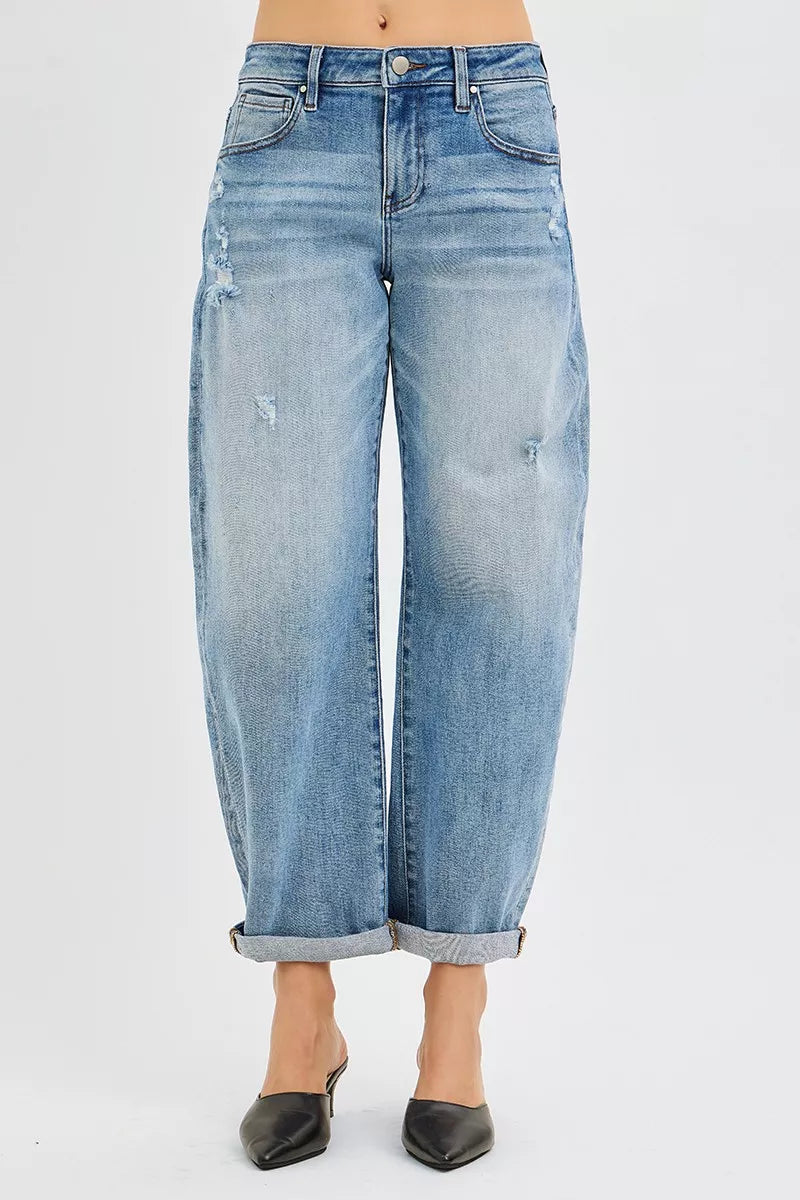 Light blue jeans with a rolled hem on a white background