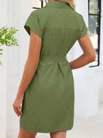 Green dress worn by a person with a white background