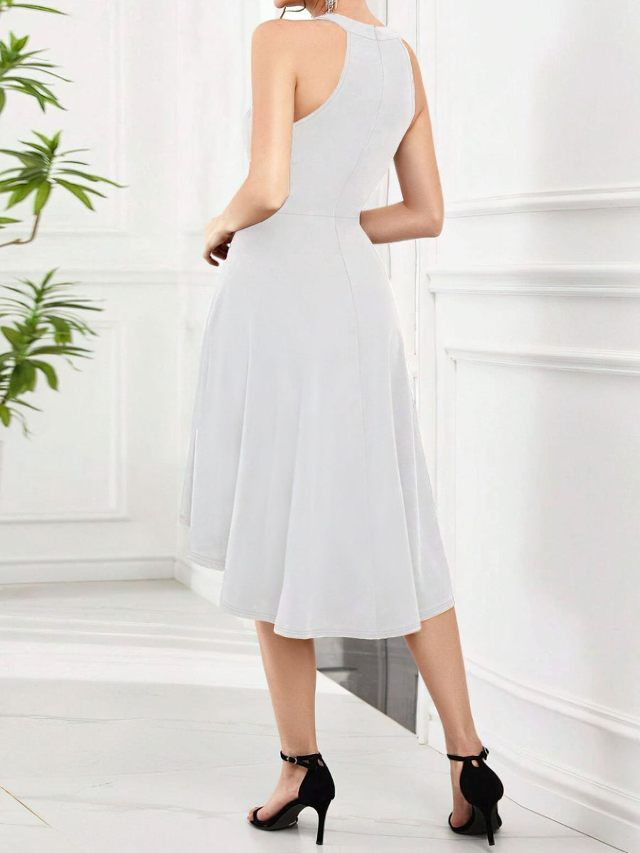 Woman wearing a light blue dress in a minimalistic room with a plant.