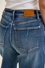 Close-up of blue jeans with a Judy Blue label on the back pocket.