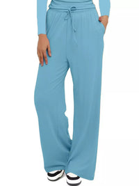 Light blue wide-leg pants worn by a person on a white background