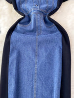 Blue denim dress with black hood on a beige background