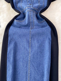 Blue denim dress with black hood on a beige background