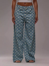 Blue polka dot pants worn by a person on a gray background