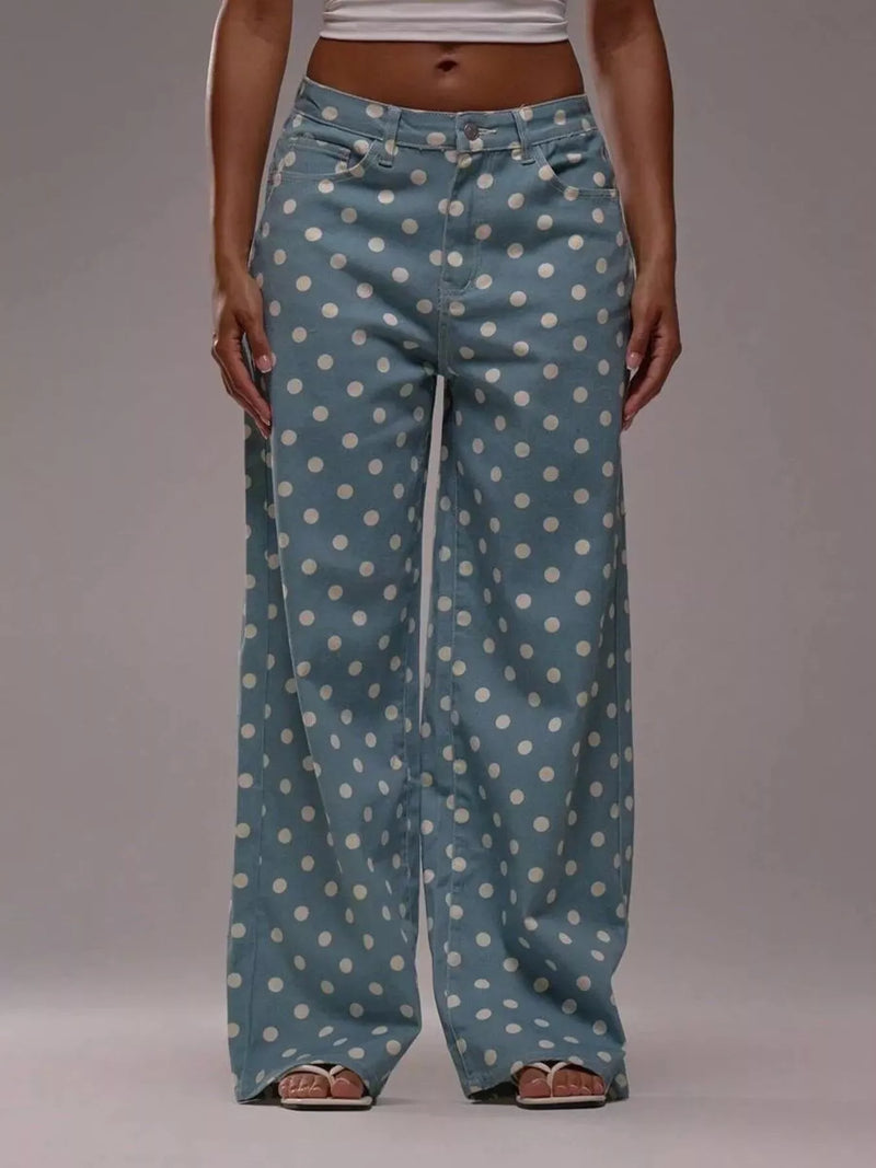 Blue polka dot pants worn by a person on a gray background