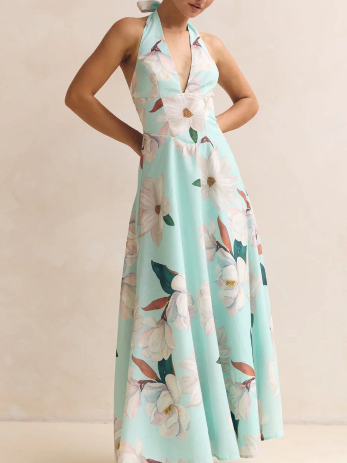 Woman wearing a floral dress with a light blue background