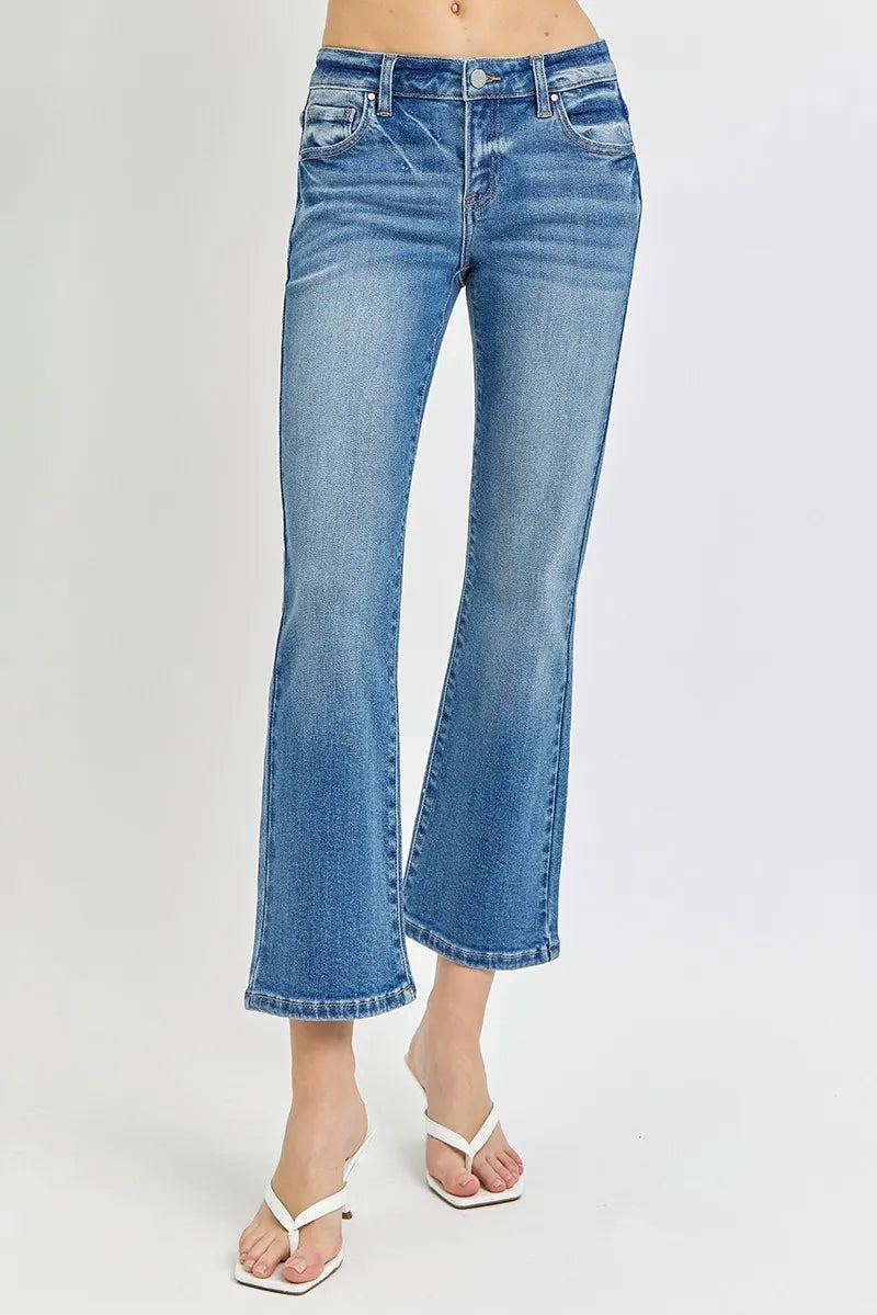 Blue jeans worn by a person on a white background
