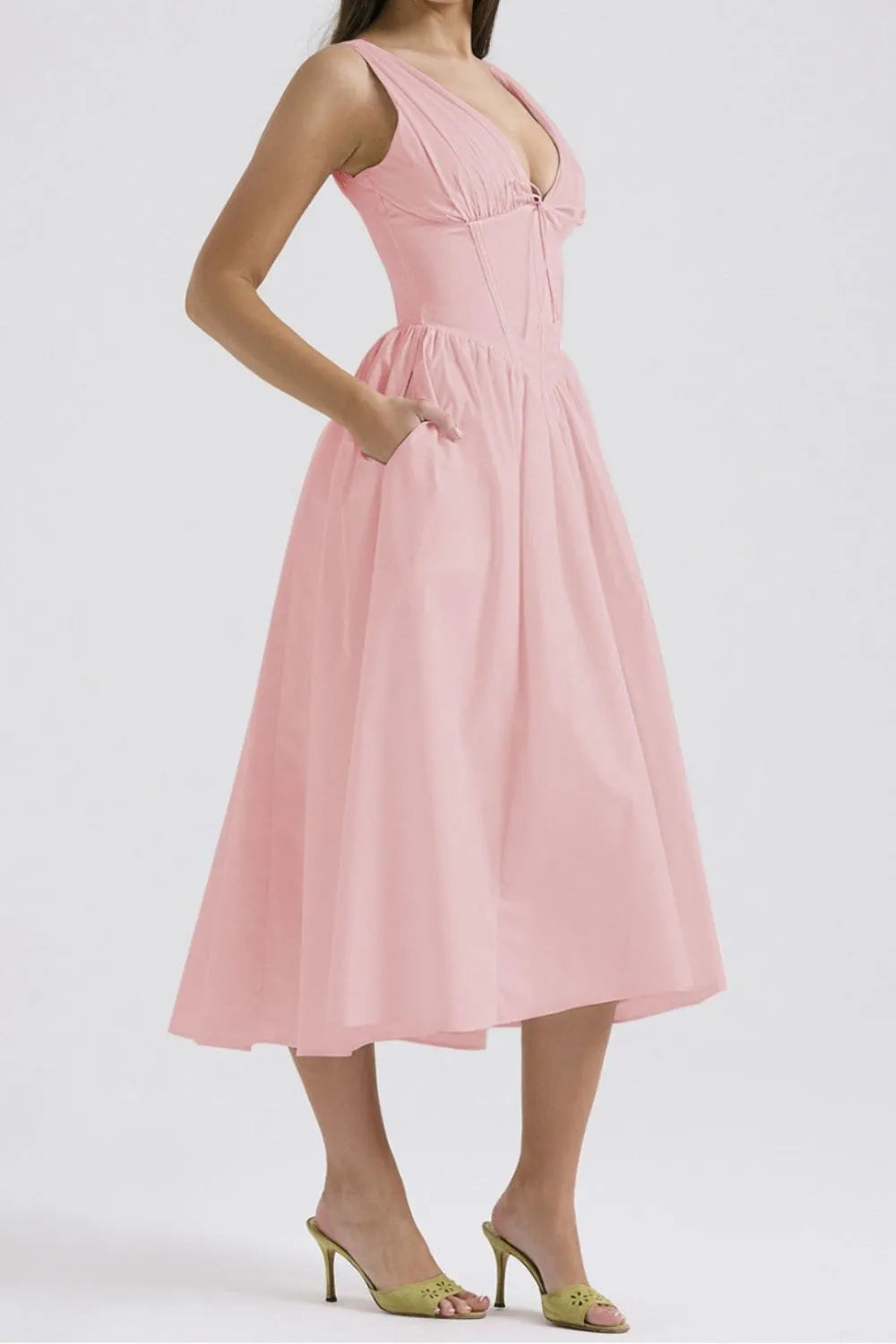 Pink dress worn by a person on a white background