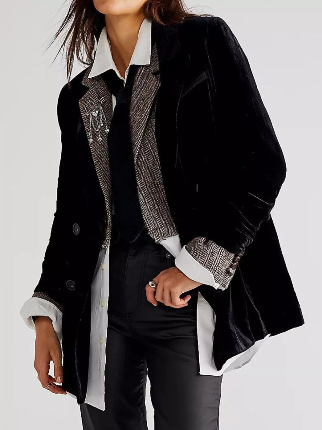 Person wearing a black coat with gray trim on a white background