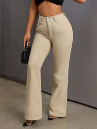 Person wearing beige high-waisted pants with a black top against a gray background