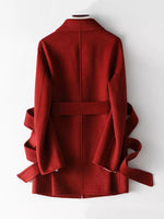 A red wrap-style coat with wide sleeves and matching waist ties, shown from the back on a white mannequin against a plain white background.
