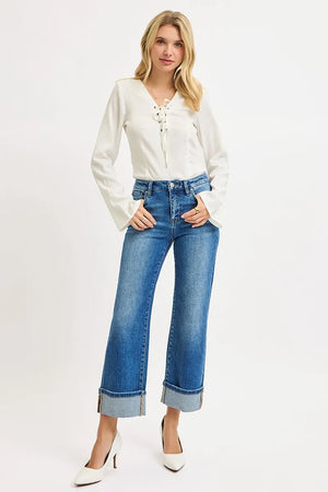 Woman wearing a white blouse and blue jeans on a white background