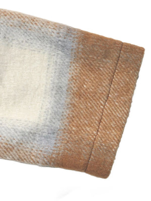 Close-up of a textured fabric with brown, beige, and gray colors on a white background