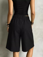 A lady showing the back of black High-Waisted Drawstring Shorts 