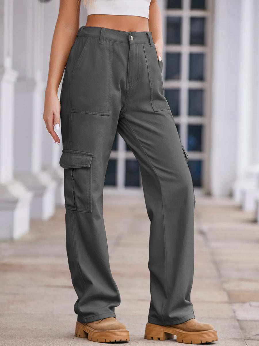Person wearing gray cargo pants standing on a wooden deck.