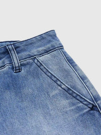 Close-up of blue denim jeans on a light gray background