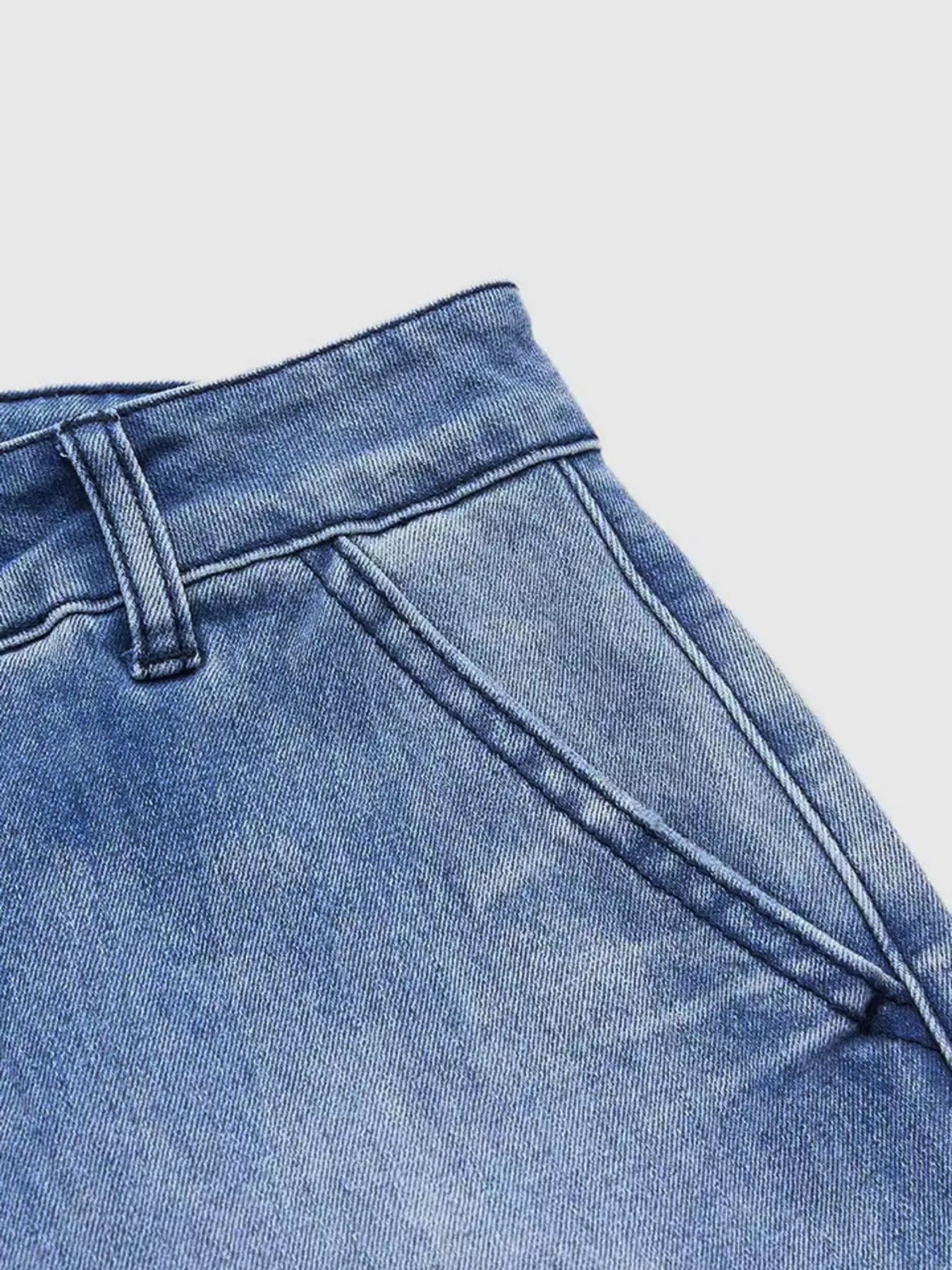 Close-up of blue denim jeans on a light gray background