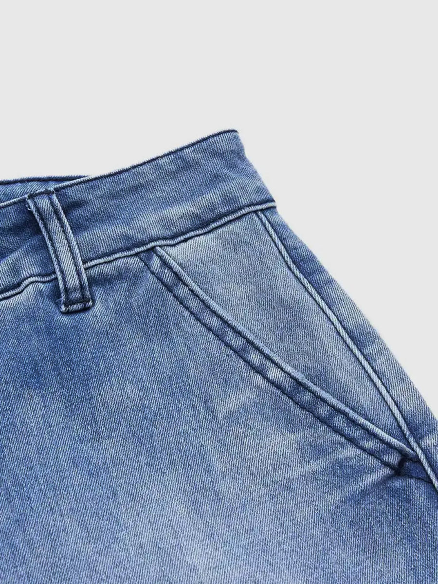 Close-up of blue denim jeans on a light gray background