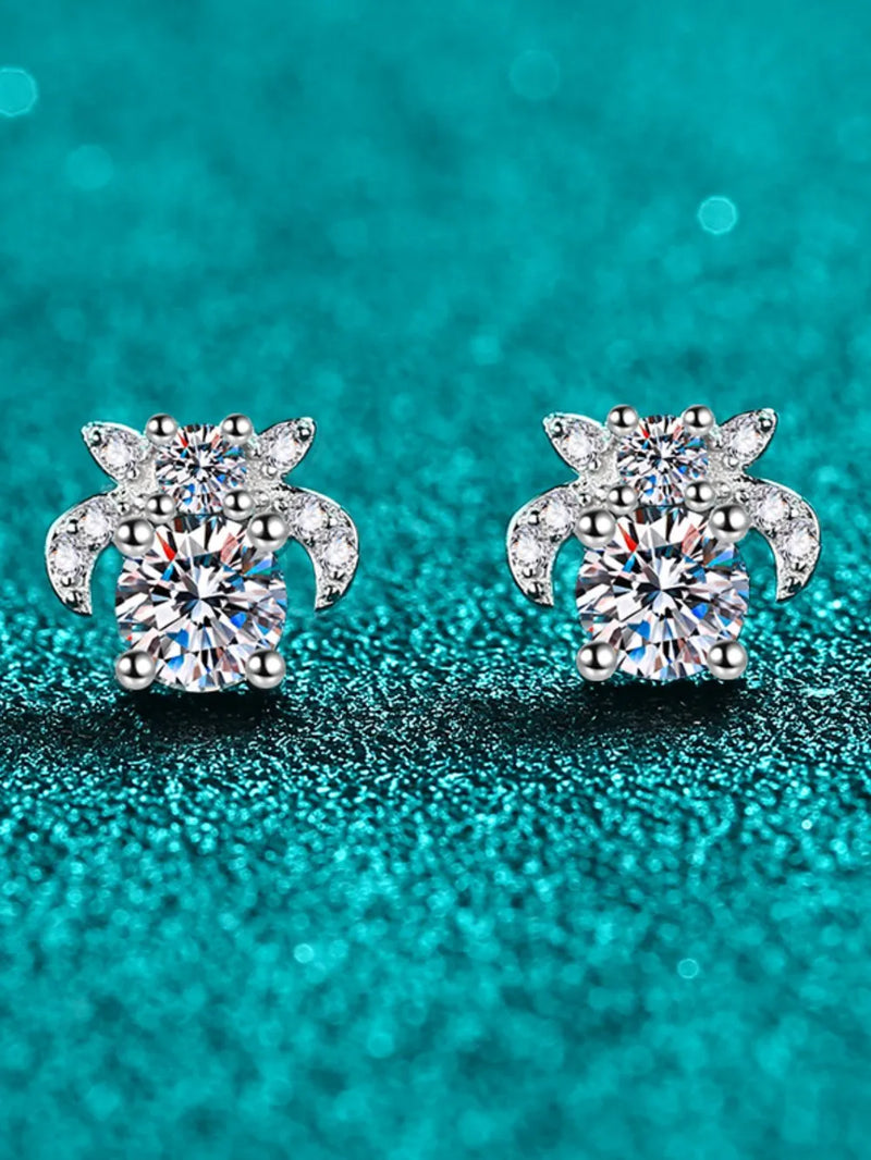 Pair of diamond stud earrings on a teal background