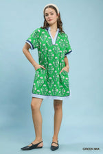 Woman wearing a green patterned dress on a light blue background