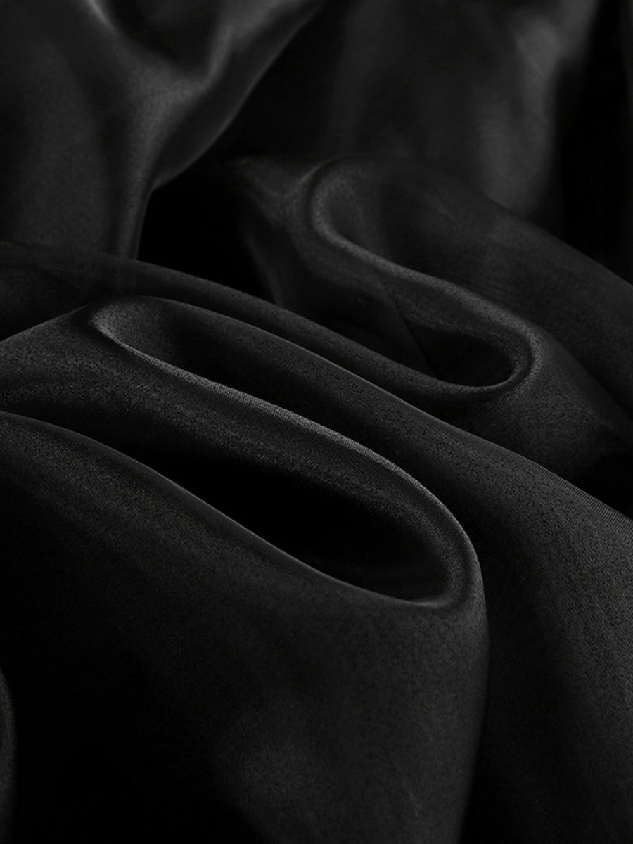 Close-up of dark fabric with folds on a black background