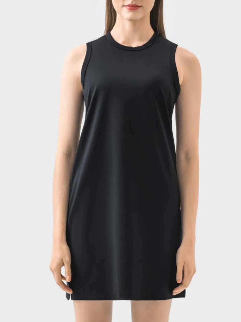 Black sleeveless dress worn by a model on a white background