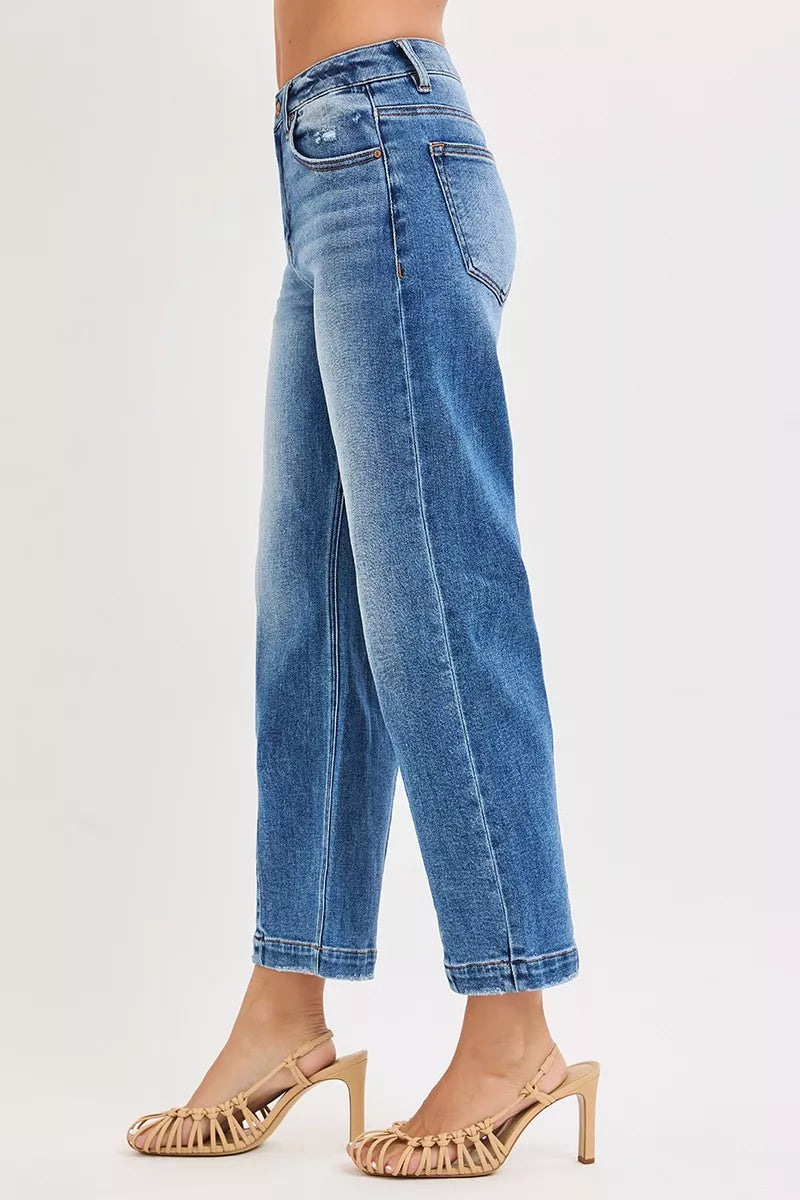 Blue jeans worn by a person on a white background