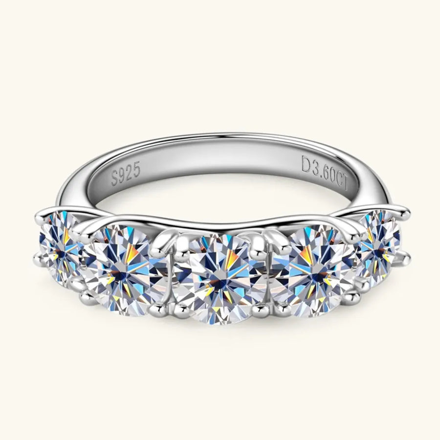 Silver ring with multiple gemstones on a white background