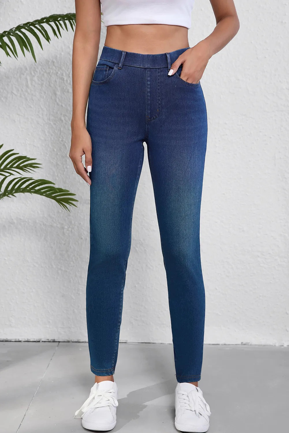 Person wearing blue jeans with a white background
