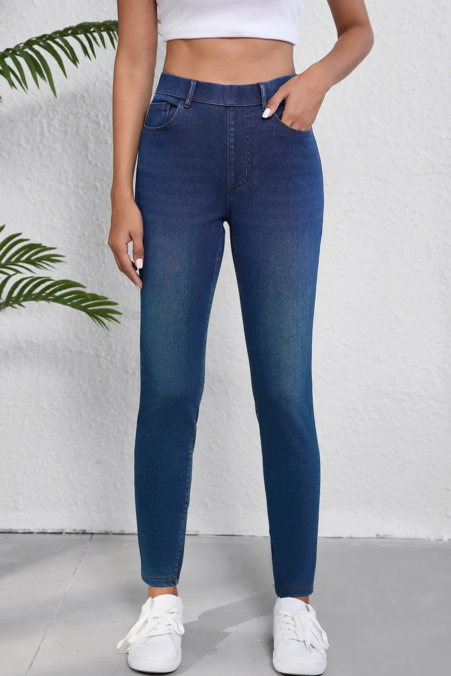Person wearing blue jeans with a white background