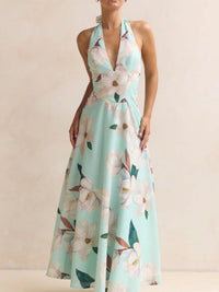 Woman wearing a floral halter neck dress on a beige background