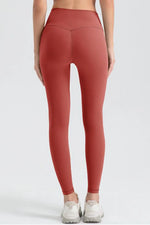 Person wearing red leggings on a white background