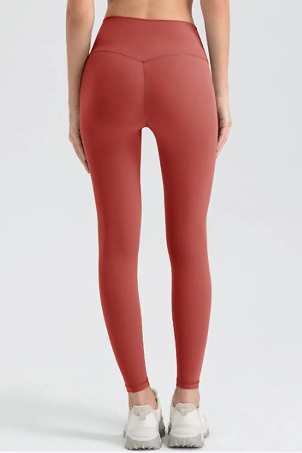 Person wearing red leggings on a white background