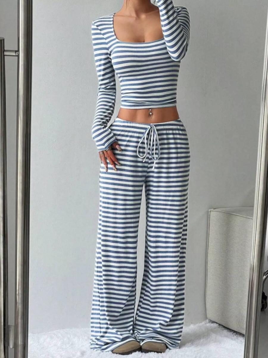 Person wearing a blue and white striped outfit in front of a mirror.