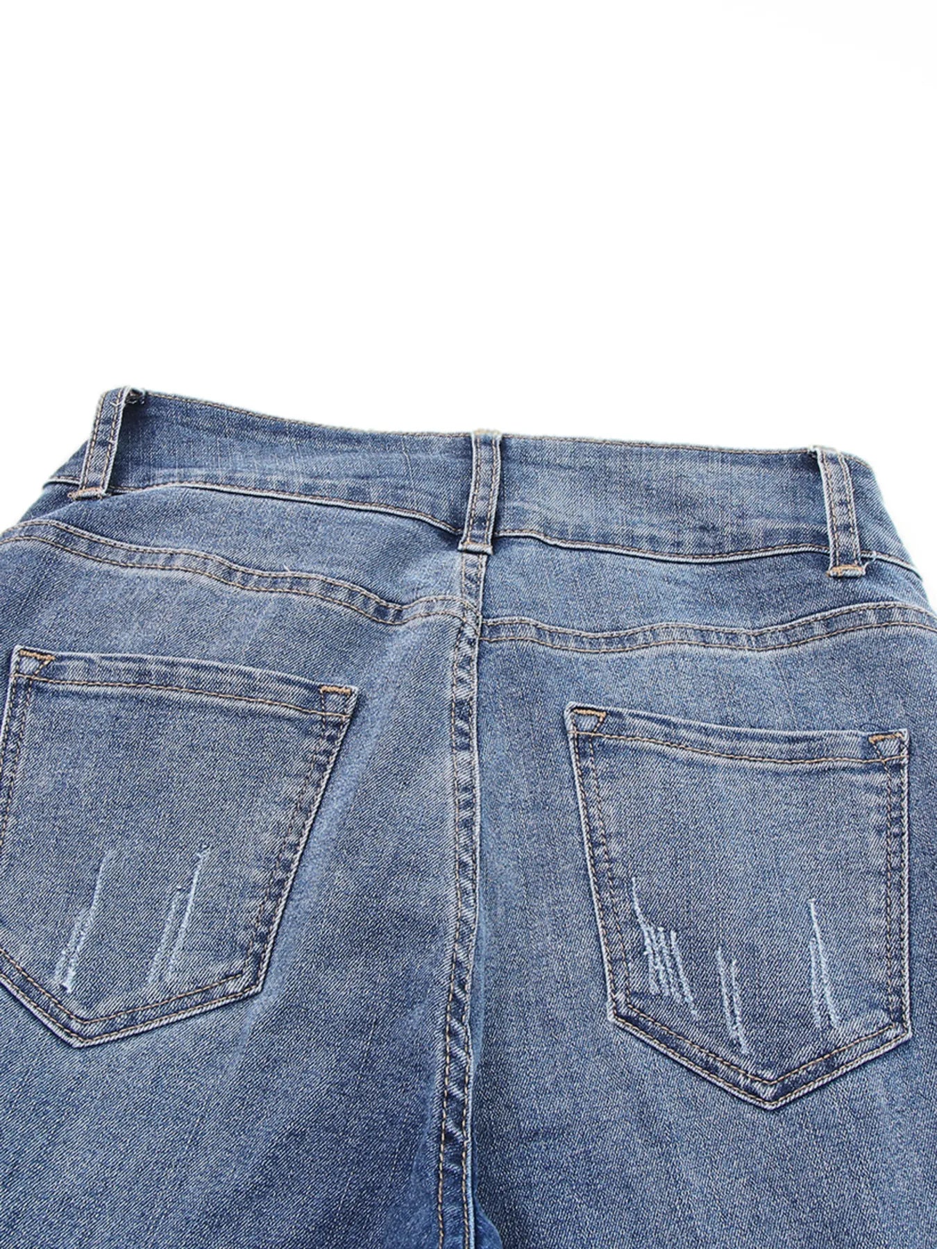 Back view of blue jeans on a white background