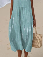 Person wearing a light blue dress on a beach