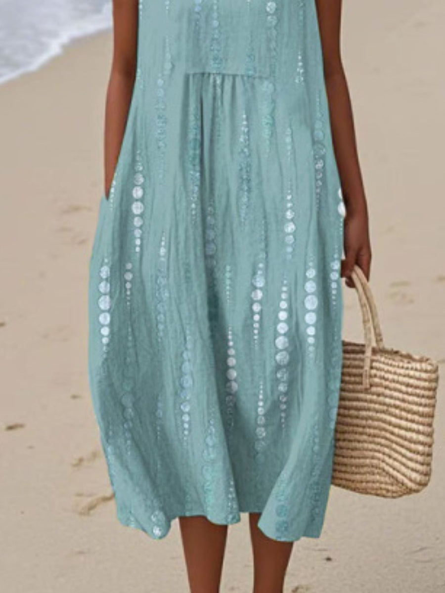 Person wearing a light blue dress on a beach