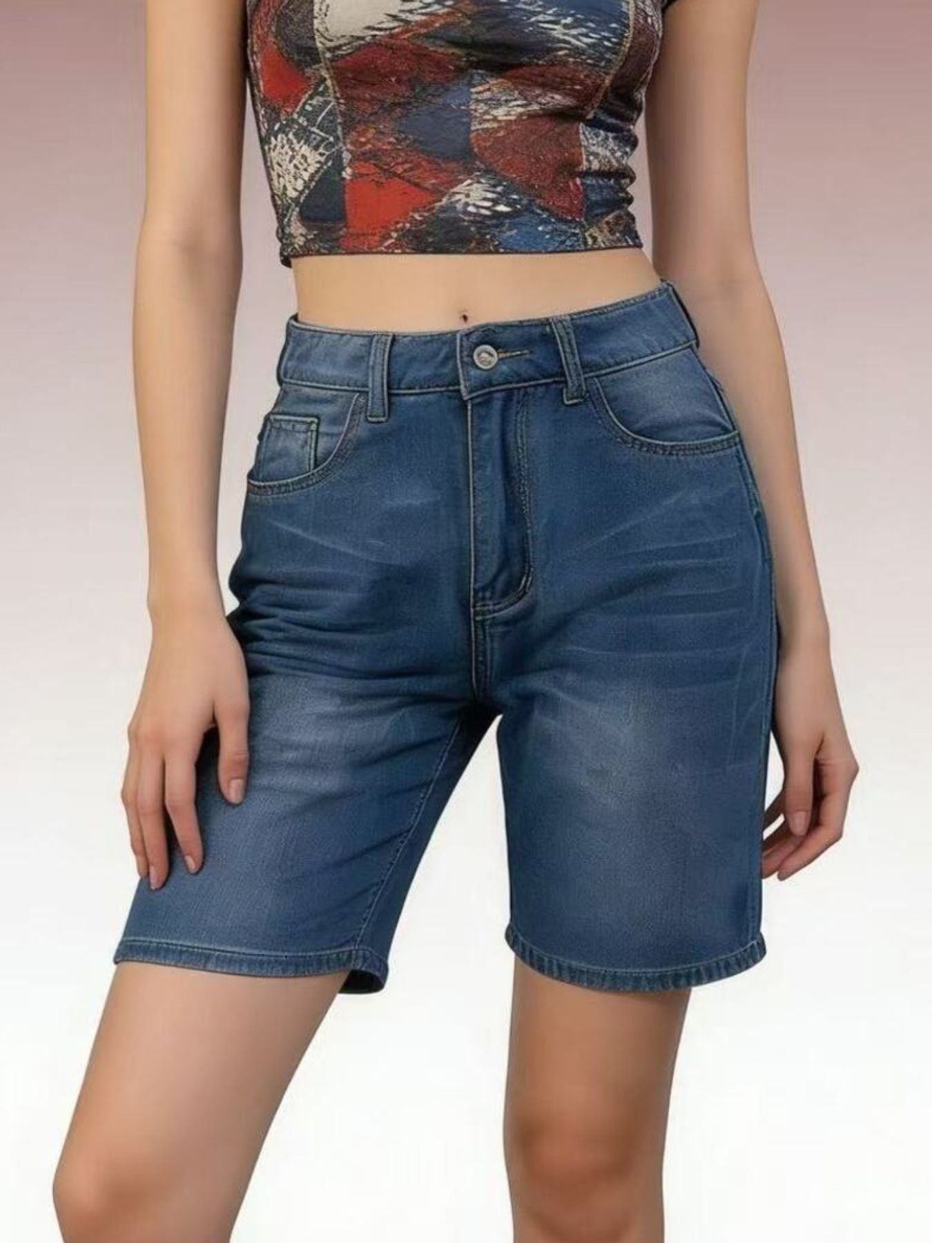 Person wearing blue denim shorts and a patterned top on a plain background