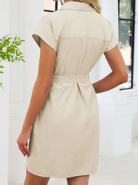 Beige dress worn by a person with a blurred background