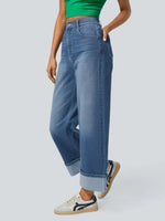 Person wearing blue jeans and a green top on a white background