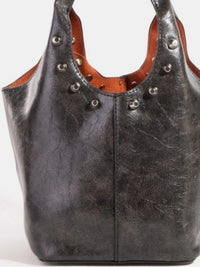 Black leather handbag with brown interior and silver studs on a white background