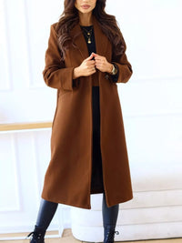Woman wearing a brown coat against a white background