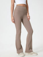 Beige flared pants worn by a person on a white background