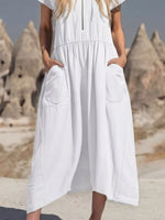 Person wearing a white dress with a scenic background of rock formations.
