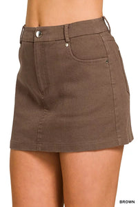 Brown skirt worn by a person on a white background