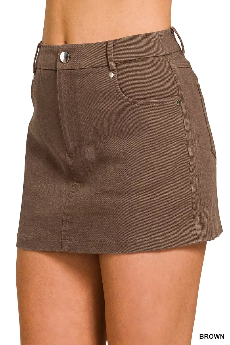 Brown skirt worn by a person on a white background