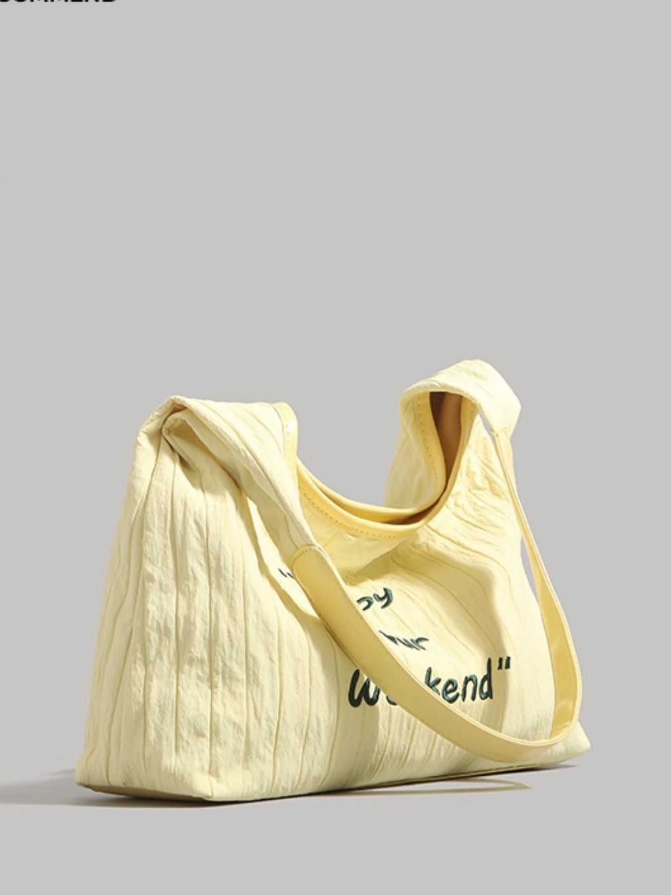 Yellow tote bag with text on a gray background