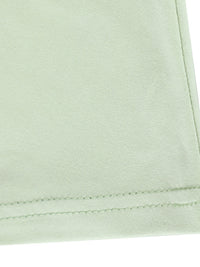 Close-up of light green fabric with a visible seam on a white background